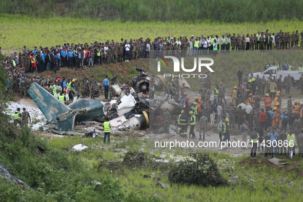 Rescuers from Nepal's security agencies are salvaging the remains of a passenger aircraft of Saurya Airlines that crashed at Tribhuvan Inter...