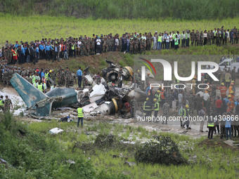 Rescuers from Nepal's security agencies are salvaging the remains of a passenger aircraft of Saurya Airlines that crashed at Tribhuvan Inter...