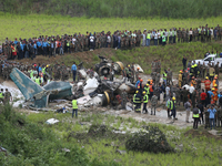 Rescuers from Nepal's security agencies are salvaging the remains of a passenger aircraft of Saurya Airlines that crashed at Tribhuvan Inter...