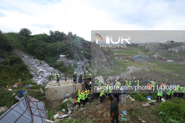 Rescuers from Nepal's security agencies are salvaging the remains of a passenger aircraft of Saurya Airlines that crashed at Tribhuvan Inter...