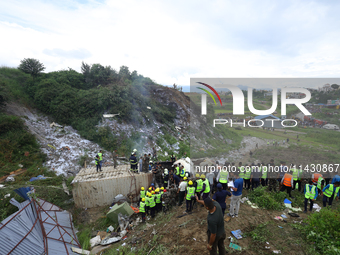 Rescuers from Nepal's security agencies are salvaging the remains of a passenger aircraft of Saurya Airlines that crashed at Tribhuvan Inter...