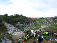 Rescuers from Nepal's security agencies are salvaging the remains of a passenger aircraft of Saurya Airlines that crashed at Tribhuvan Inter...