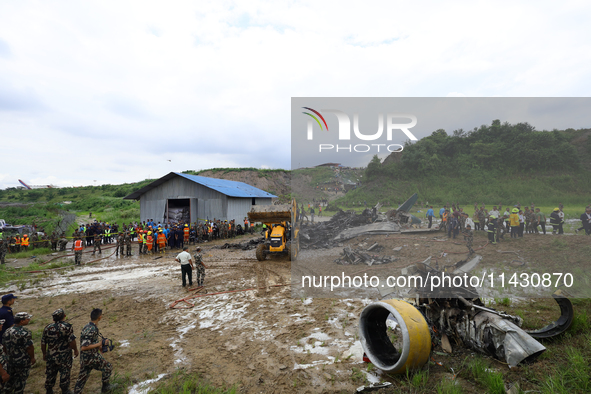 Rescuers from Nepal's security agencies are salvaging the remains of a passenger aircraft of Saurya Airlines that crashed at Tribhuvan Inter...