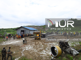 Rescuers from Nepal's security agencies are salvaging the remains of a passenger aircraft of Saurya Airlines that crashed at Tribhuvan Inter...