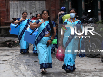 Health workers are walking during a polio vaccination campaign in Patan, Lalitpur, on July 24, 2024. The Nepal government is starting a four...