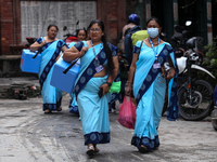 Health workers are walking during a polio vaccination campaign in Patan, Lalitpur, on July 24, 2024. The Nepal government is starting a four...