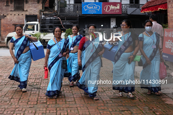 Health workers are walking during a polio vaccination campaign in Patan, Lalitpur, on July 24, 2024. The Nepal government is starting a four...