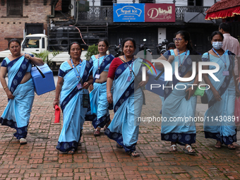 Health workers are walking during a polio vaccination campaign in Patan, Lalitpur, on July 24, 2024. The Nepal government is starting a four...