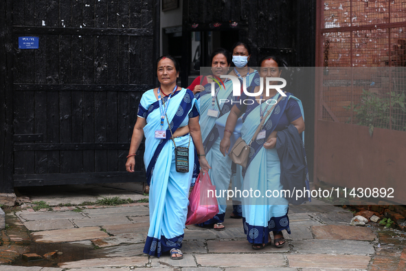 Health workers are walking during a polio vaccination campaign in Patan, Lalitpur, on July 24, 2024. The Nepal government is starting a four...