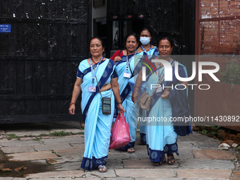 Health workers are walking during a polio vaccination campaign in Patan, Lalitpur, on July 24, 2024. The Nepal government is starting a four...