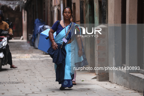 A health worker is walking during a polio vaccination campaign in Patan, Lalitpur, on July 24, 2024. The Nepal government is starting a four...