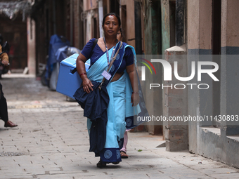 A health worker is walking during a polio vaccination campaign in Patan, Lalitpur, on July 24, 2024. The Nepal government is starting a four...