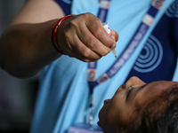 A health worker is administering a polio vaccine drop to a child in Patan, Lalitpur, on July 24, 2024. The Nepal government is starting a fo...