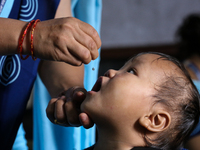 A health worker is administering a polio vaccine drop to a child in Patan, Lalitpur, on July 24, 2024. The Nepal government is starting a fo...