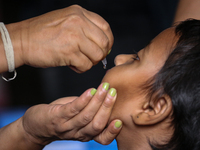 A health worker is administering a polio vaccine drop to a child in Patan, Lalitpur, on July 24, 2024. The Nepal government is starting a fo...