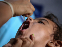 A health worker is administering a polio vaccine drop to a child in Patan, Lalitpur, on July 24, 2024. The Nepal government is starting a fo...