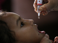 A health worker is administering a polio vaccine drop to a child in Patan, Lalitpur, on July 24, 2024. The Nepal government is starting a fo...