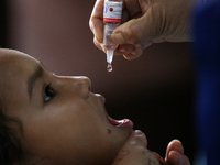 A health worker is administering a polio vaccine drop to a child in Patan, Lalitpur, on July 24, 2024. The Nepal government is starting a fo...