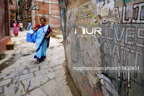 A Nepali health worker head is going door-to-door to administer polio drops to children under the age of 5 following the government's specia...