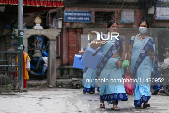 Nepali health workers are heading towards a school to administer polio drops to children under the age of 5 following the government's speci...