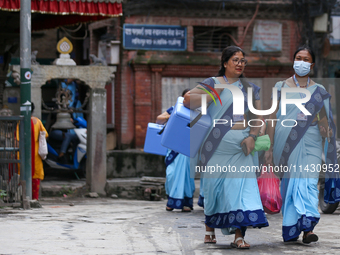 Nepali health workers are heading towards a school to administer polio drops to children under the age of 5 following the government's speci...