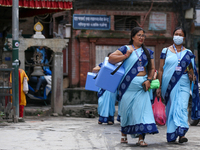 Nepali health workers are heading towards a school to administer polio drops to children under the age of 5 following the government's speci...