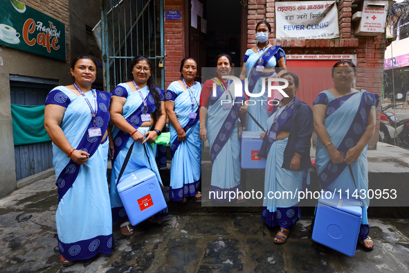 Nepali health workers are posing for a photo before heading out door-to-door to administer polio drops to children under the age of 5 follow...