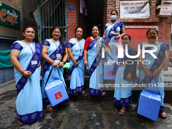 Nepali health workers are posing for a photo before heading out door-to-door to administer polio drops to children under the age of 5 follow...