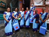 Nepali health workers are posing for a photo before heading out door-to-door to administer polio drops to children under the age of 5 follow...