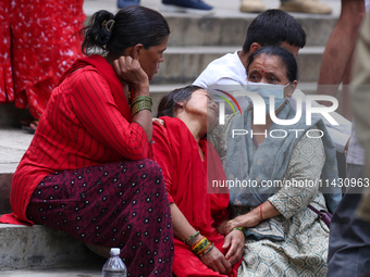 Family members and relatives of Nepal's domestic flight carrier Saurya Airlines are waiting for the bodies of their loved ones outside the m...