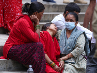 Family members and relatives of Nepal's domestic flight carrier Saurya Airlines are waiting for the bodies of their loved ones outside the m...