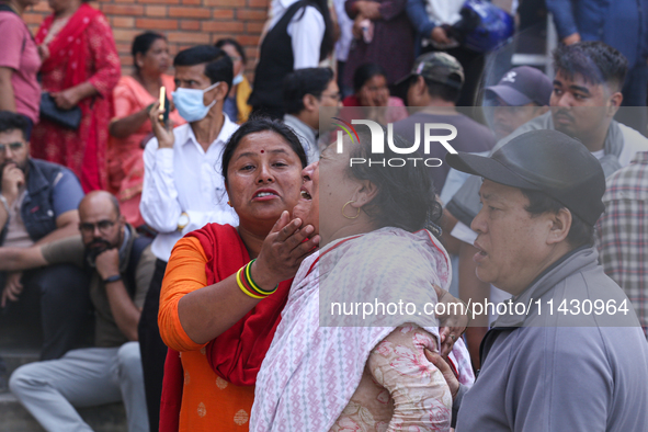 Family members and relatives of Nepal's domestic flight carrier Saurya Airlines are waiting for the bodies of their loved ones outside the m...