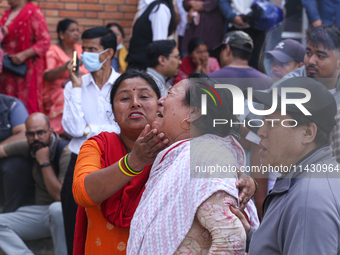 Family members and relatives of Nepal's domestic flight carrier Saurya Airlines are waiting for the bodies of their loved ones outside the m...