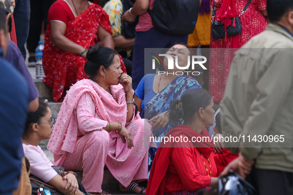 Family members and relatives of Nepal's domestic flight carrier Saurya Airlines are waiting for the bodies of their loved ones outside the m...