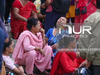 Family members and relatives of Nepal's domestic flight carrier Saurya Airlines are waiting for the bodies of their loved ones outside the m...