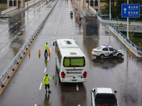 Police officers are on duty on a flooded road after heavy rain in Sanmenxia, China, on July 24, 2024. (