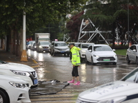 Vehicles are running on a flooded road after heavy rain in Sanmenxia, Henan province, China, on July 24, 2024. (