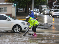 A police officer is on duty on a flooded road after heavy rain in Sanmenxia, Henan province, China, on July 24, 2024. (