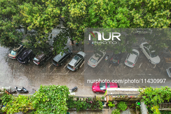 Vehicles are running on a flooded road after heavy rain in Sanmenxia, Henan province, China, on July 24, 2024. 