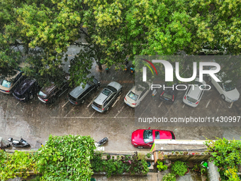 Vehicles are running on a flooded road after heavy rain in Sanmenxia, Henan province, China, on July 24, 2024. (