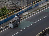 A scavenger is crossing a road in the central business district of Jakarta, Indonesia, on July 24, 2024. (