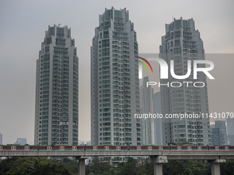 Cars of the LRT train are passing through the business district of Jakarta, Indonesia, on July 24, 2024. (