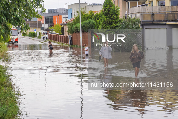 A street is flooding after a strong storm and downpour in Gdansk, Poland, on July 24, 2024. Heavy downpours and strong storms are causing nu...