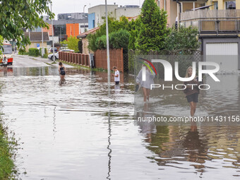 A street is flooding after a strong storm and downpour in Gdansk, Poland, on July 24, 2024. Heavy downpours and strong storms are causing nu...