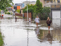 A street is flooding after a strong storm and downpour in Gdansk, Poland, on July 24, 2024. Heavy downpours and strong storms are causing nu...