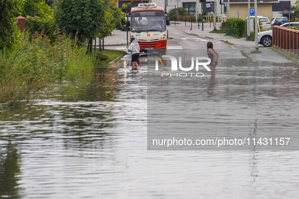 A street is flooding after a strong storm and downpour in Gdansk, Poland, on July 24, 2024. Heavy downpours and strong storms are causing nu...