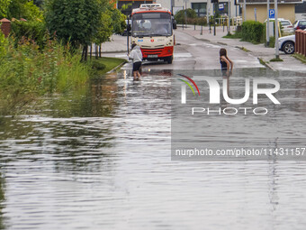 A street is flooding after a strong storm and downpour in Gdansk, Poland, on July 24, 2024. Heavy downpours and strong storms are causing nu...