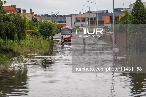 A street is flooding after a strong storm and downpour in Gdansk, Poland, on July 24, 2024. Heavy downpours and strong storms are causing nu...