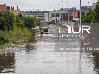 A street is flooding after a strong storm and downpour in Gdansk, Poland, on July 24, 2024. Heavy downpours and strong storms are causing nu...