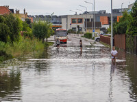 A street is flooding after a strong storm and downpour in Gdansk, Poland, on July 24, 2024. Heavy downpours and strong storms are causing nu...